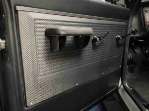 A close up of the door handle on an airplane.